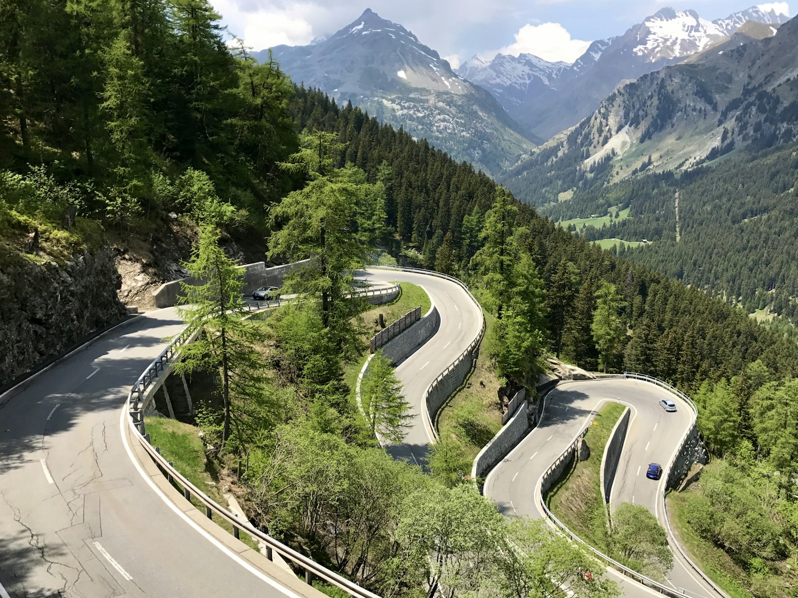 Hairpin bends stacked down the Maloja Pass in the Swiss Alps